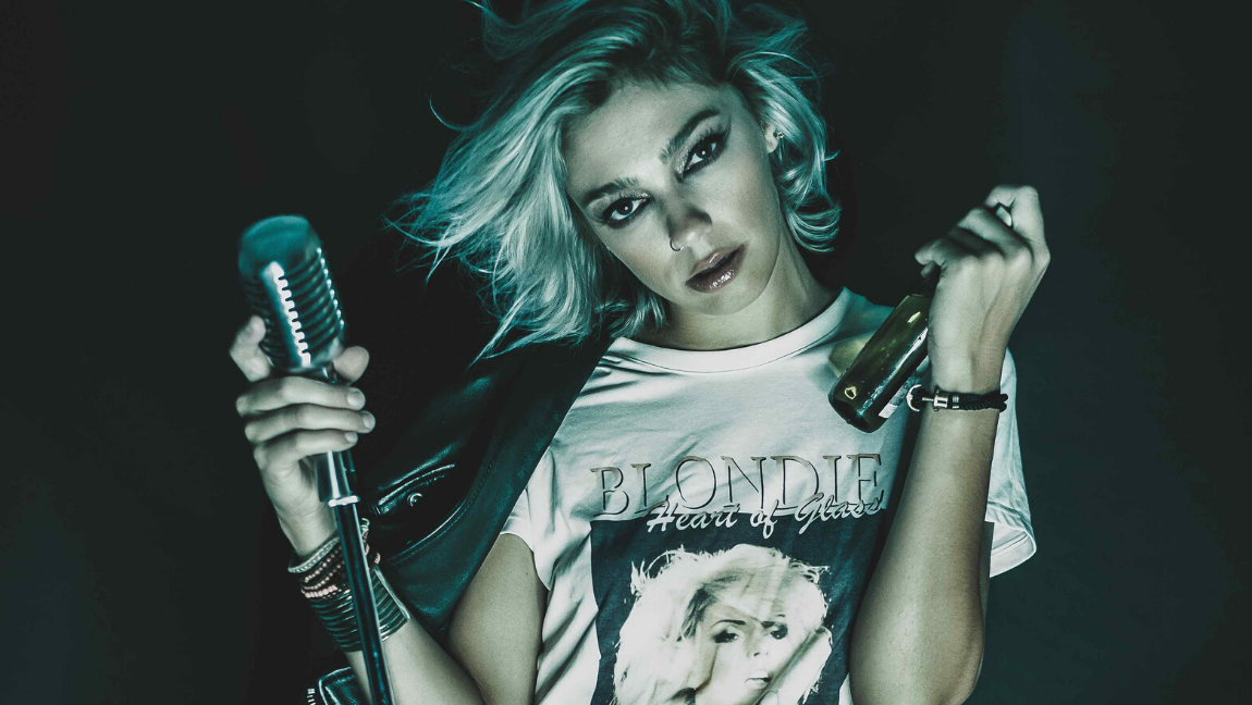 Woman holds a microphone.